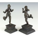 A pair of late 19th Century Burmese bronze Figures of Chinlon players, Rangoon, Each balancing the
