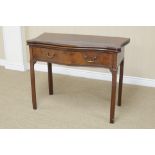 A George III mahogany Writing/Library Table with serpentine shape fold-over top above frieze drawers