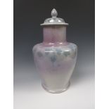 A Ruskin pottery lidded baluster Vase, the lid decorated border of entwined leaves, the base with