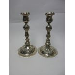 A pair of 19th Century Continental silver Candlesticks with floral embossed stems and shaped