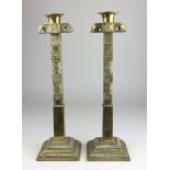 A large pair of late 19th Century Sinhalese engraved brass Candlesticks, 16 ¼ in high (2)