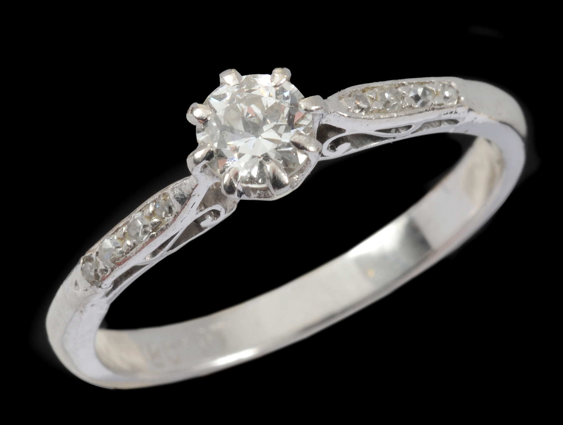 A Diamond single stone Ring claw-set brilliant-cut stone with small stones pavé-set to shoulders,