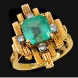 A 1970's Emerald and Diamond Cluster Ring claw-set step-cut emerald estimated 3.00 cts, within