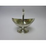 A George III silver oval Basket engraved initial, with reeded swing handle on pedestal base,