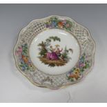 A late Meissen reticulated Plate with floral and lattice moulded rim, central panel of lady and