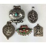 Five Indian white metal or enamel Pendants, Including a locket decorated with Kartikey with