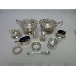 A pair of George V silver pierced circular Baskets with single scroll handles on pedestal bases,