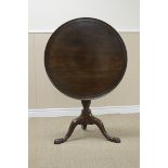 A Georgian mahogany Tripod Table with circular dish top on turned stem with fluted column and shaped