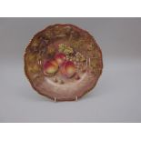 A Royal Worcester Plate with shaped moulded edge, gilded painted peaches, cherry and grapes on a