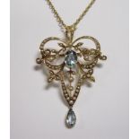 An Aquamarine and Seed Pearl Pendant/Brooch, the openwork plaque millegrain-set oval-cut