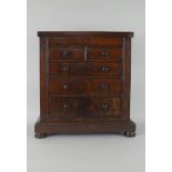A Victorian mahogany Apprentice Piece Chest with secret drawer above two short and three long