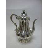 A Victorian silver Coffee Pot of pear shape with leafage scroll engraving, melon finial, London