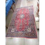A bordered Persian Rug with floral medallion and corner design on a red ground, 7ft 3in x 4ft 3in,