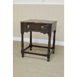 An antique oak Side Table with replacement top above single drawer and shaped frieze on turned and
