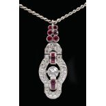 A Diamond and Ruby Pendant set brilliant-cut diamond within tonneau shaped frame pavé-set eight-