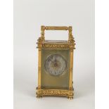 A 19th Century brass cased Carriage Clock with pierced foliate decoration and silvered dial, on