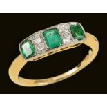 An Art Deco Emerald and Diamond Ring millegrain-set three calibre-cut emeralds interspersed with two