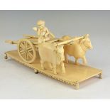 A 19th Century Indian ivory model of a Bullock Cart, Bengal, The flatbed cart with turbaned