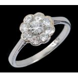 A Diamond Cluster Ring claw-set brilliant-cut stone within frame of eight pavé-set stones, stamped