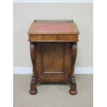 A Victorian burr walnut Davenport with pierced gallery above red leather writing slope, four real