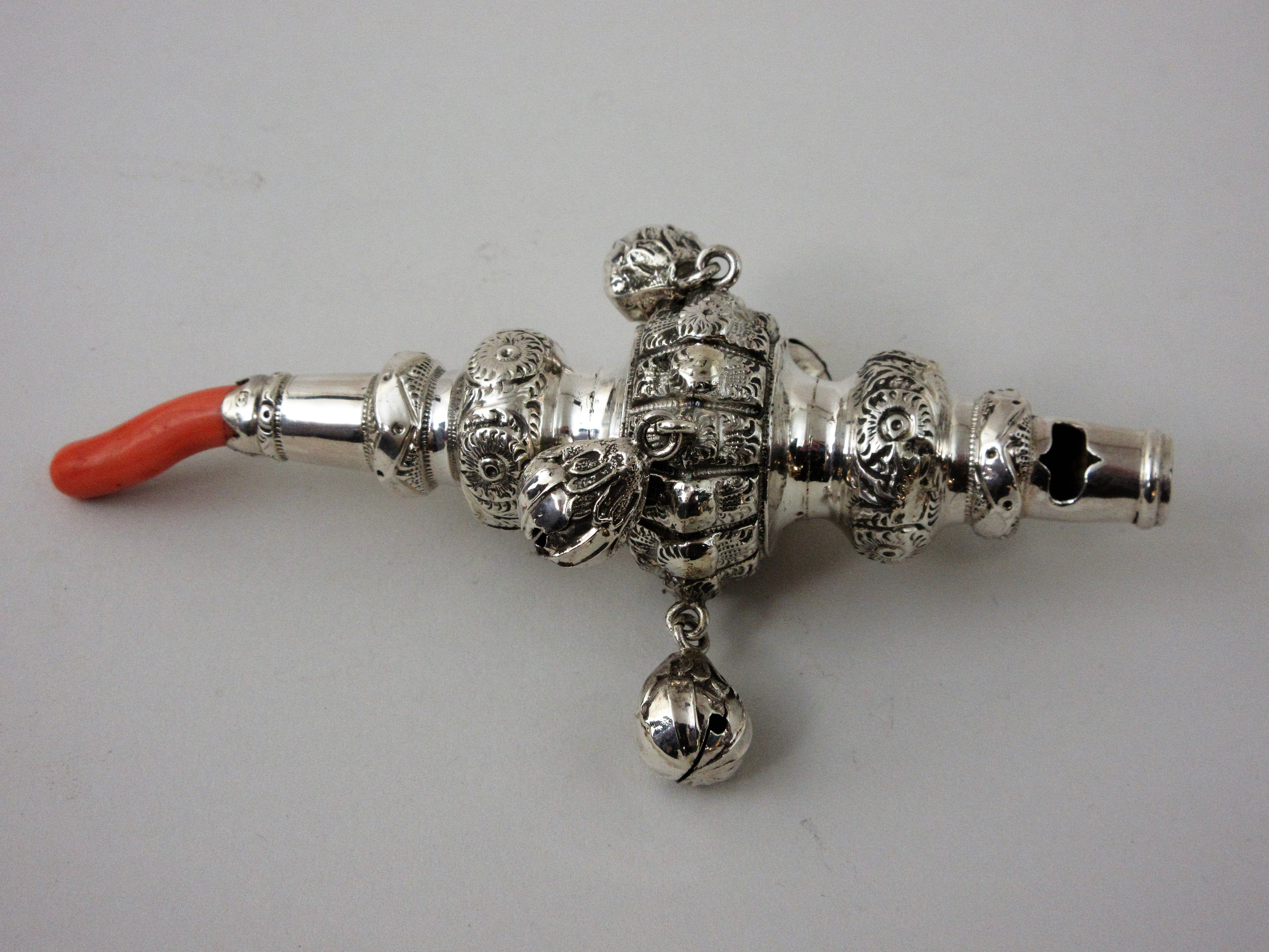 A Victorian silver Rattle with rosette embossing and four applied bells, Birmingham 1894