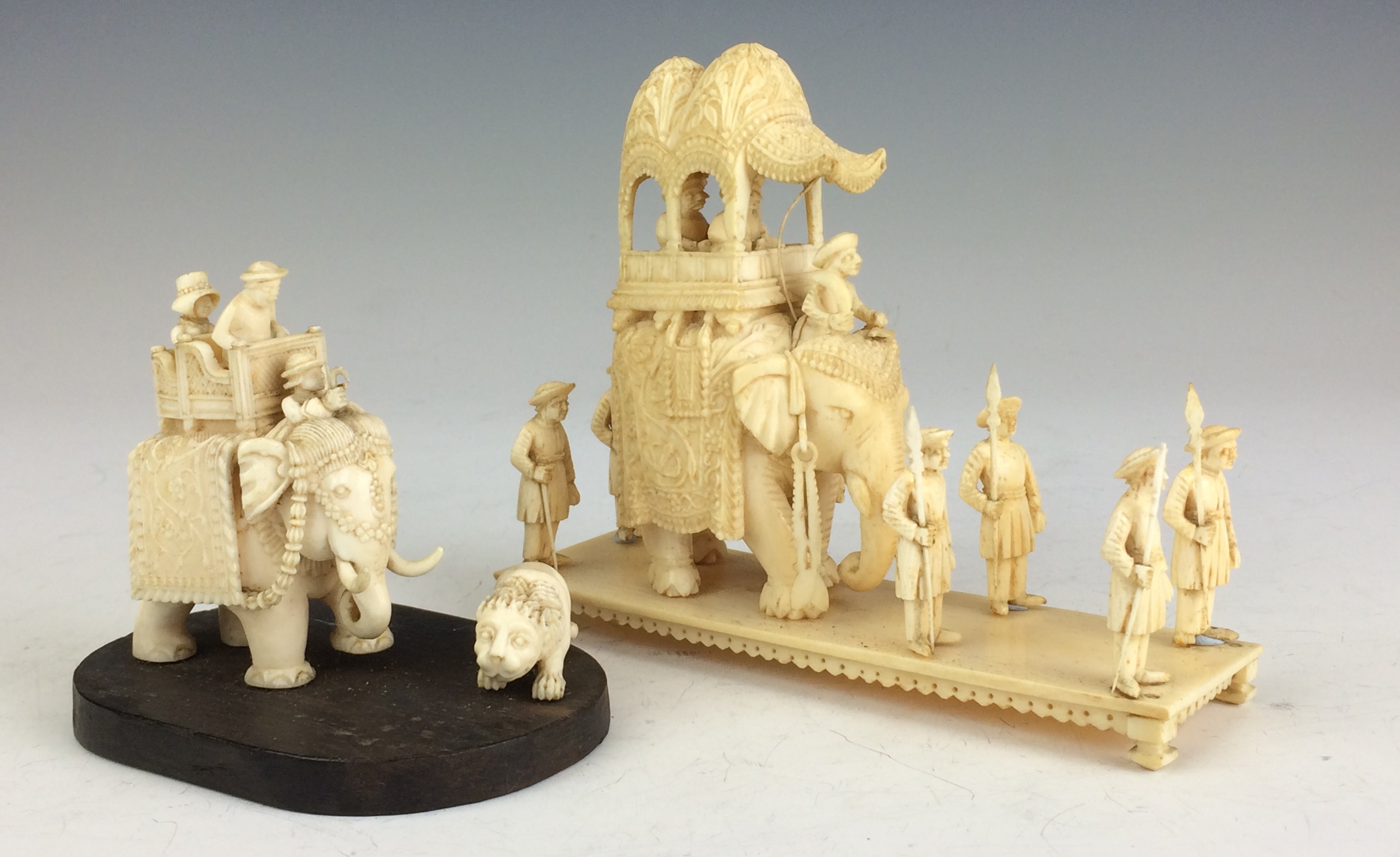 A 19th Century Indian ivory Model of a tiger hunt and an elephant procession, The former carved with