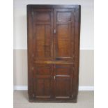 An antique oak Double Corner Cupboard with two pairs of solid panelled doors, 6ft 7in