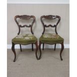 Four Victorian rosewood Single Chairs with scroll carved frames, floral woolwork seats on cabriole