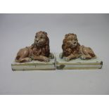 A pair of early 19th Century Wood and Caldwell pearlware Figures of recumbant lions with painted