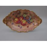 A Royal Worcester oval shaped Dish, moulded edge and shell handles, painted plums, grapes and