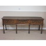 An 18th Century oak Dresser Base fitted three drawers on four baluster turned and square front legs,