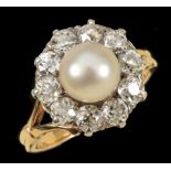 A Cultured Pearl and Diamond Cluster Ring set single pearl within a frame of ten old-cut diamonds,