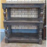 A Jacobean style oak three tier Open Cupboard, the upper and central tiers above carved friezes,