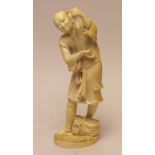 A Japanese ivory Okimono of a Farmer,Meiji PeriodStanding holding a kiku stem, a basket at his feet,