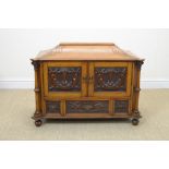 A late 19th Century carved oak Table Cabinet with a pair of carved panelled doors above three