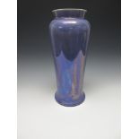 A tall Ruskin Vase of tapering baluster form, having mottled purple blue iridescent glaze, impressed