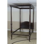A 19th Century mahogany Campaign Four Poster Bed with carved fretwork surround above pair of plain