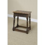An antique oak Joint Stool with moulded frieze on turned and square supports, 16 x 10in