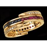 A Sapphire, Ruby and Diamond Day and Night Ring channel-set round rubies and sapphires between