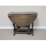 An 18th Century oak oval Gateleg Table with shaped silhouette end supports and gates, 3ft 3in