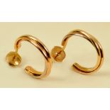 A pair of Cartier Earrings each having tri-colour twisted gold bands in 18ct gold, stamped