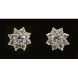 A pair of Diamond Cluster Earrings each claw-set brilliant-cut stone within a frame of eight smaller