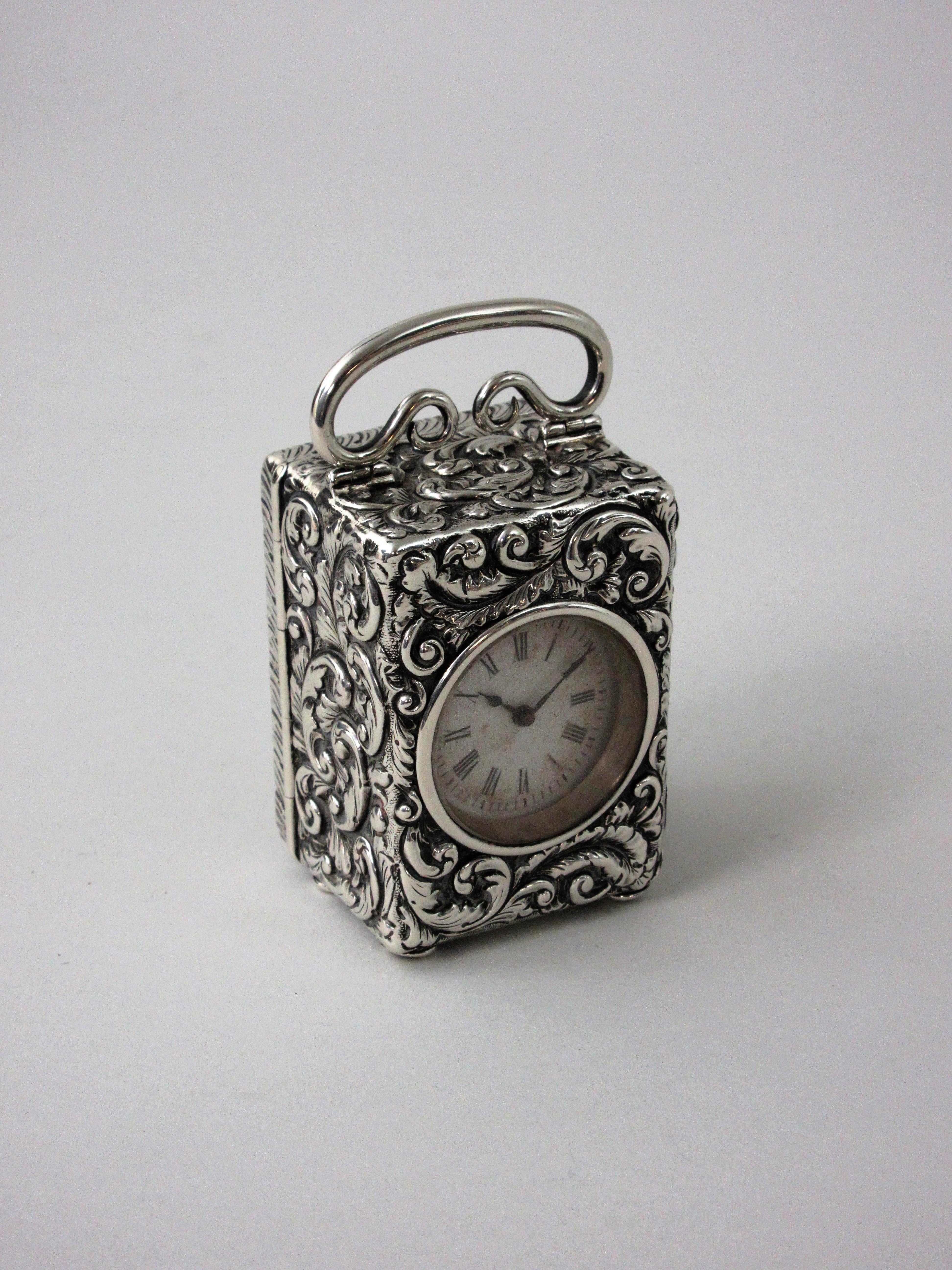 A Victorian silver cased small Carriage Clock with scroll embossing, London 1897, 3in