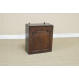 An 18th Century oak Spice Cupboard with single fielded panelled door enclosing nine small drawers