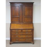 A 19th Century oak Bureau Bookcase inlaid and cross-banded in mahogany, the upper pair of doors
