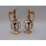 A pair of Royal Crown Derby Ewers, moulded scroll handles, richly gilt with moulded shaped plinth,