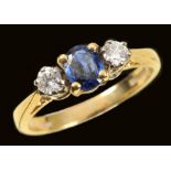 A Sapphire and Diamond three stone Ring claw-set oval-cut sapphire between two brilliant-cut