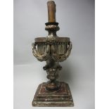 An early carved wood and silvered Candlestick in the form of an urn with swags on leafage column and