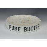 A ceramic circular Butter Slab with letters reading 'Pure Butter' on the side, 15 1/2 in D