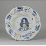 A late 17th Century Dutch Delft lobed Dish, painted to the centre with a naive portrait of William